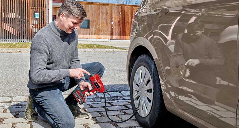 man working with a car air compressor