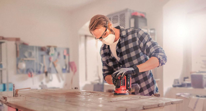 Man using a rotating sander