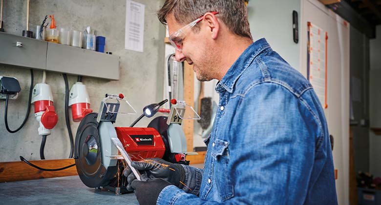 Man useing a bench grinder