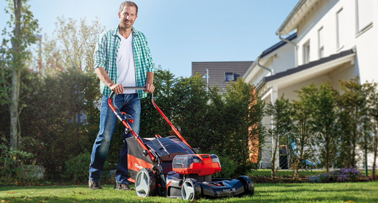 Man mowing grass with a lawn mower